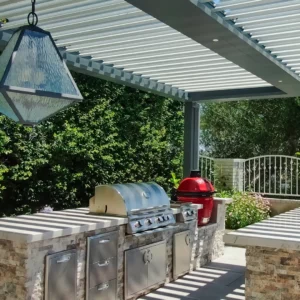Louvered pergola shading an outdoor kitchen