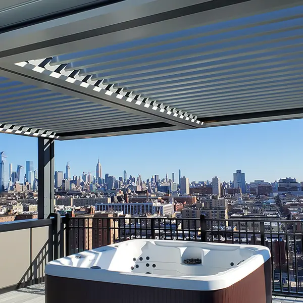 Pergola with a roof over a hot tub on a rooftop with a city view.