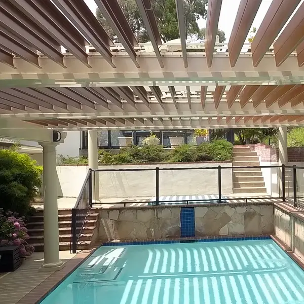 Pergola installed over a pool deck, providing shade and enhancing the outdoor space.