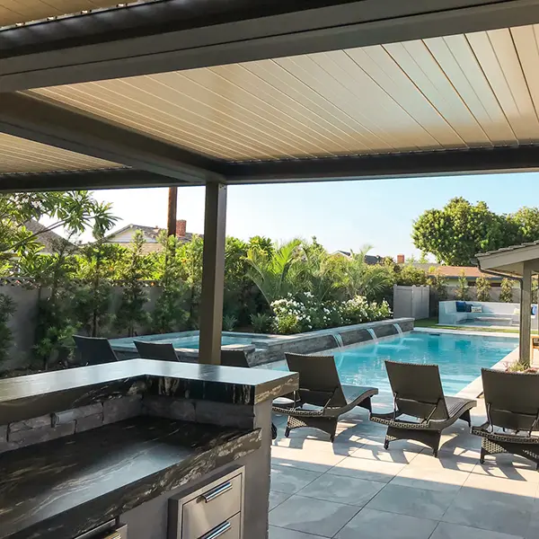 Pergola providing shade over a poolside bar and seating area.