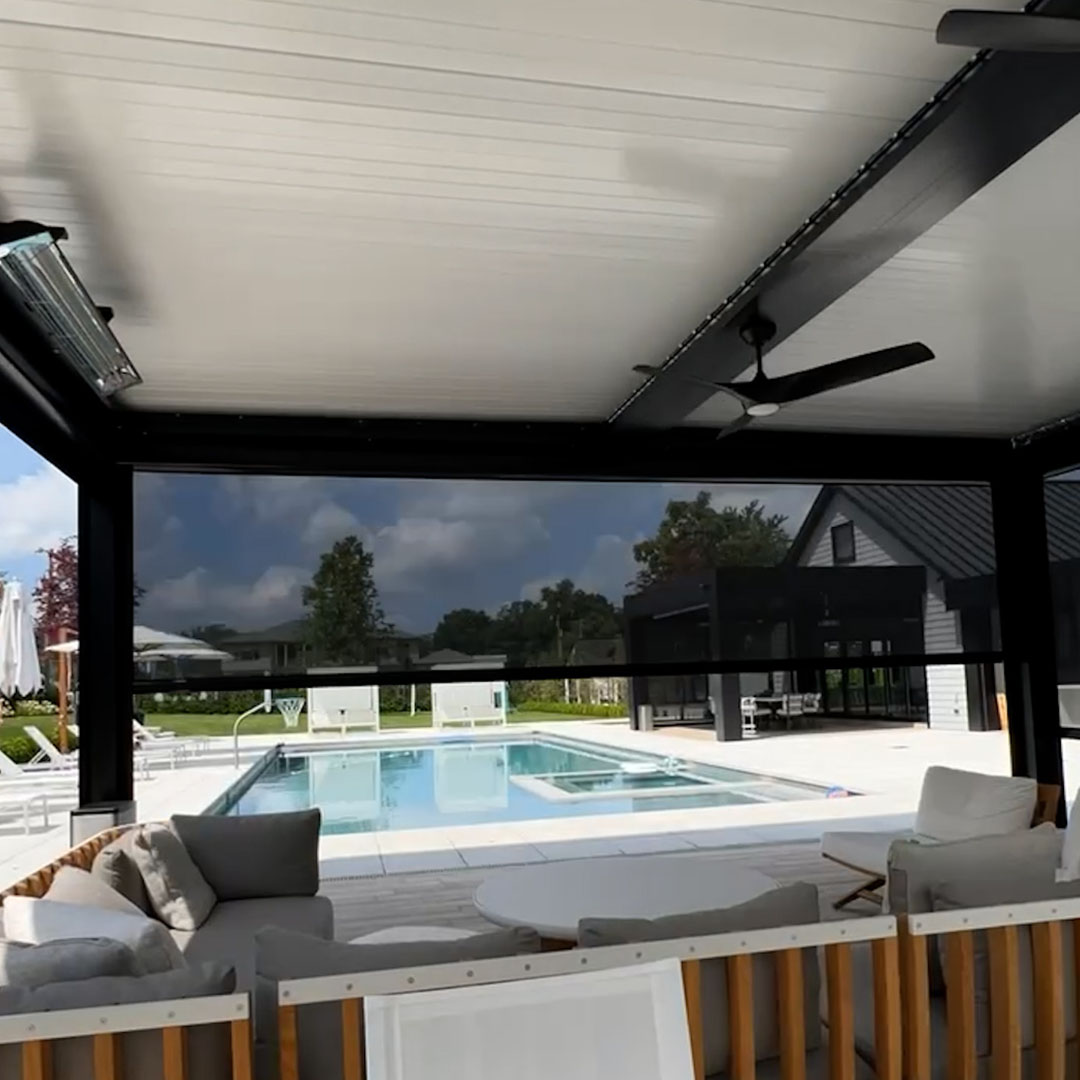 A modern pergola with a louvered roof providing shade to a seating area by the pool.