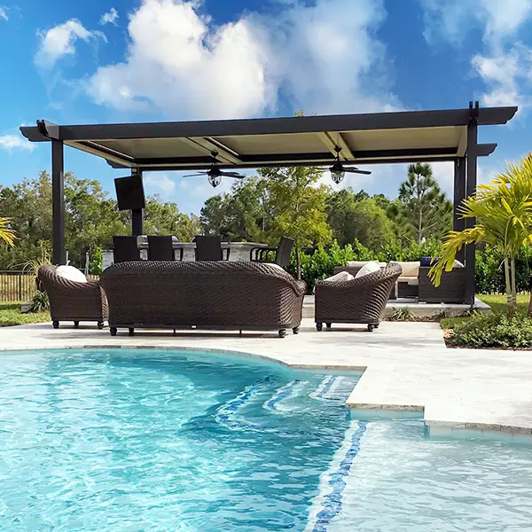 Pergola providing shade over a poolside seating area with outdoor furniture.