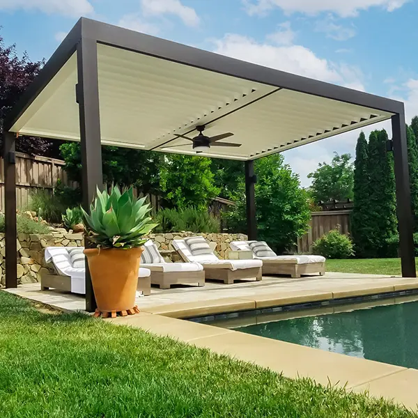 Pergola providing shade over lounge chairs beside a pool.