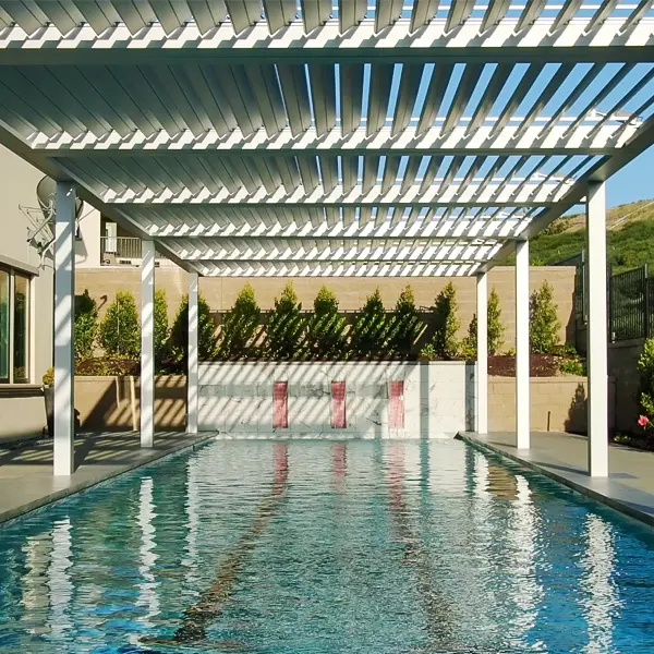 Pergola installed over a swimming pool, providing adjustable shade.