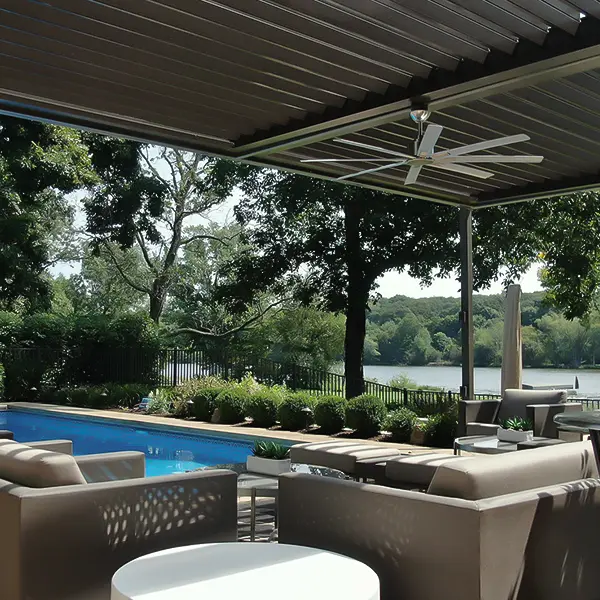 Modern louvered pergola providing shade over a stylish poolside seating area with a lake view.